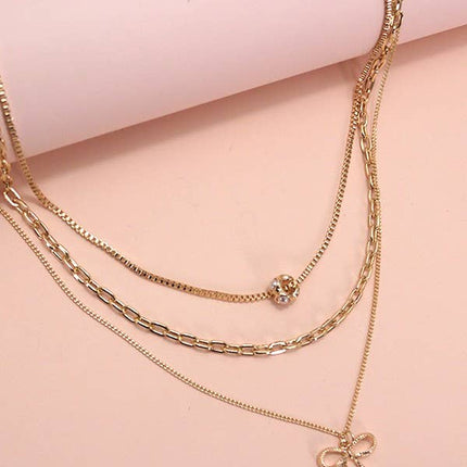 MULTI LAYER PEARL BOW CAHRM NECKLACE