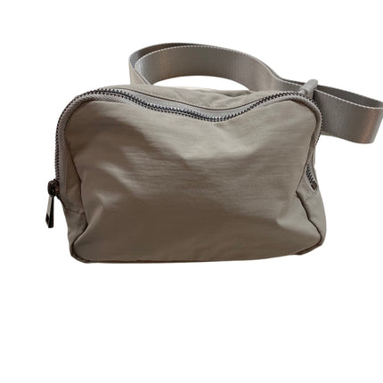 The Keely belt bag — shown open with compartments